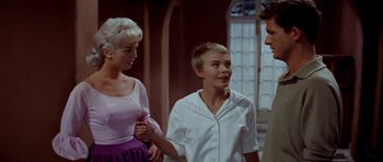 Movie still from “Bonjour Tristesse” (1958), directed by Otto Preminger – Two women and a man standing next to each other in a room; Medium shot, Over the shoulder angle