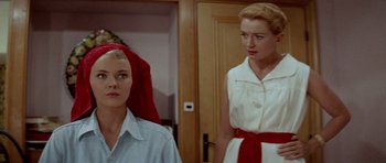 Movie still from “Bonjour Tristesse” (1958), directed by Otto Preminger – Two women standing next to each other in front of a door; Close Up shot, Low angle
