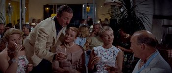 Movie still from “Bonjour Tristesse” (1958), directed by Otto Preminger – A group of people sitting at a table with wine glasses; Medium shot, Low angle