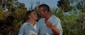 Movie still from “Bonjour Tristesse” (1958), directed by Otto Preminger – A man and a woman smiling at each other; Medium shot, Low angle