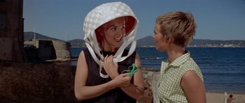 Movie still from “Bonjour Tristesse” (1958), directed by Otto Preminger – A woman wearing a hat and scissors in her hands; Medium shot, Low angle