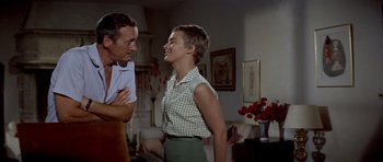 Movie still from “Bonjour Tristesse” (1958), directed by Otto Preminger – A man and a woman are talking in a living room; Medium shot, Low angle