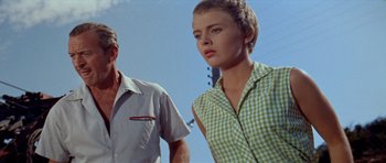 Movie still from “Bonjour Tristesse” (1958), directed by Otto Preminger – A man and a woman standing next to each other in front of power lines; Close Up shot, Low angle