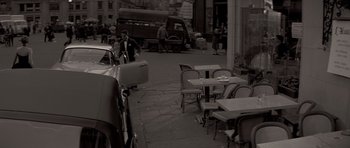 Movie still from “Bonjour Tristesse” (1958), directed by Otto Preminger – An old photo of an outdoor cafe with tables and chairs; Wide shot, High angle