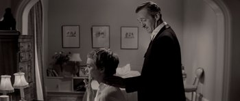 Movie still from “Bonjour Tristesse” (1958), directed by Otto Preminger – A black and white photo of a man and a boy; Medium shot, High angle