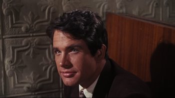 Movie still from “Bonnie and Clyde” (1967), directed by Arthur Penn – A person wearing a suit and tie; Close Up shot, High angle