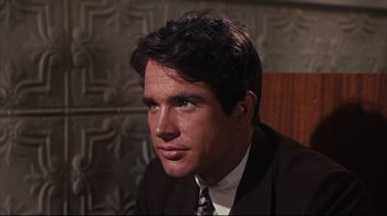 Movie still from “Bonnie and Clyde” (1967), directed by Arthur Penn – A person wearing a suit and tie; Close Up shot, Over the shoulder angle