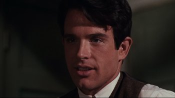 Movie still from “Bonnie and Clyde” (1967), directed by Arthur Penn – A person wearing a suit and tie; Close Up shot, Over the shoulder angle