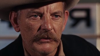 Movie still from “Bonnie and Clyde” (1967), directed by Arthur Penn – A person wearing a cowboy hat; Close Up shot, Low angle