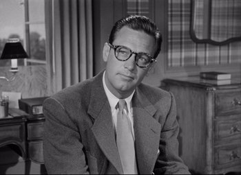 Movie still from “Born Yesterday” (1950), directed by George Cukor – An old photo of a man in a suit; Close Up shot, Low angle