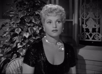 Movie still from “Born Yesterday” (1950), directed by George Cukor – An old photo of a woman in a black dress; Close Up shot, High angle