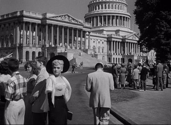 Movie still from “Born Yesterday” (1950), directed by George Cukor – A black and white photo of people in front of the capitol building; Wide shot, Low angle