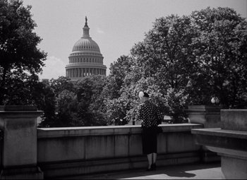 Movie still from “Born Yesterday” (1950), directed by George Cukor – An older woman looking at the capitol building; Extreme Wide shot, Low angle