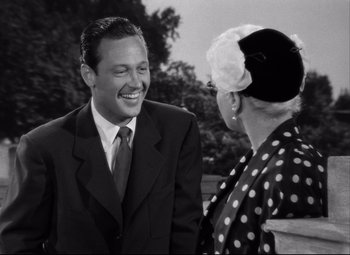 Movie still from “Born Yesterday” (1950), directed by George Cukor – A man and a woman are talking to each other; Close Up shot, Over the shoulder angle