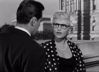 Movie still from “Born Yesterday” (1950), directed by George Cukor – A man and a woman talking to each other outside; Close Up shot, Over the shoulder angle