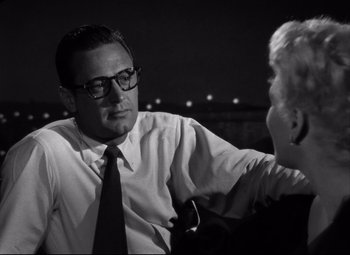 Movie still from “Born Yesterday” (1950), directed by George Cukor – A black and white photo of a man talking to another man; Close Up shot, Over the shoulder angle