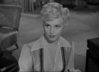 Movie still from “Born Yesterday” (1950), directed by George Cukor – A black - and - white photo of a woman with blonde hair; Close Up shot, High angle