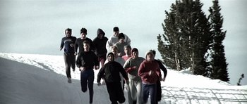 Movie still from “Born on the Fourth of July” (1989), directed by Oliver Stone – A group of young people running in the snow; Wide shot, High angle