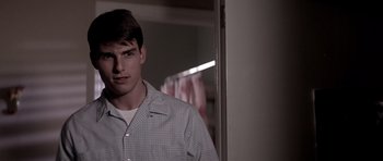 Movie still from “Born on the Fourth of July” (1989), directed by Oliver Stone – A young man standing in front of a mirror; Close Up shot, Over the shoulder angle