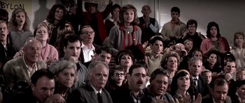 Movie still from “Born on the Fourth of July” (1989), directed by Oliver Stone – A group of people sitting in front of each other; Medium shot, High angle