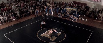 Movie still from “Born on the Fourth of July” (1989), directed by Oliver Stone – Two men are wrestling in a wrestling ring; Extreme Wide shot, High angle