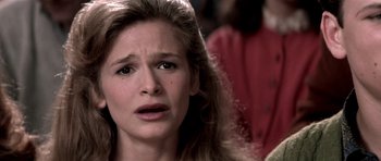 Movie still from “Born on the Fourth of July” (1989), directed by Oliver Stone – A person with long blonde hair; Close Up shot, Over the shoulder angle