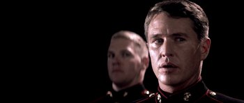 Movie still from “Born on the Fourth of July” (1989), directed by Oliver Stone – Two men in military uniforms; Close Up shot, Over the shoulder angle