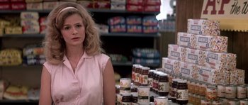 Movie still from “Born on the Fourth of July” (1989), directed by Oliver Stone – A woman standing in front of many jars of food; Close Up shot, Over the shoulder angle