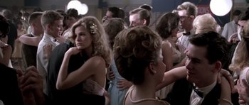 Movie still from “Born on the Fourth of July” (1989), directed by Oliver Stone – A group of people that are standing in a room together; Medium shot, Over the shoulder angle