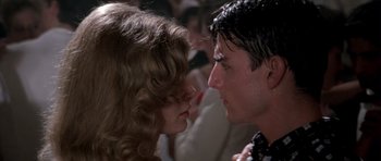 Movie still from “Born on the Fourth of July” (1989), directed by Oliver Stone – A man and a woman face to face in front of a crowd of onlookers; Close Up shot, Over the shoulder angle
