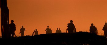 Movie still from “Born on the Fourth of July” (1989), directed by Oliver Stone – A group of soldiers standing on top of a hill; Extreme Wide shot, Low angle