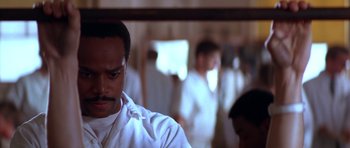 Movie still from “Born on the Fourth of July” (1989), directed by Oliver Stone – A person in a room with other people; Close Up shot, Low angle