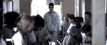 Movie still from “Born on the Fourth of July” (1989), directed by Oliver Stone – A group of people sitting in a room; Medium shot, Low angle