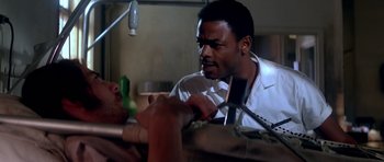 Movie still from “Born on the Fourth of July” (1989), directed by Oliver Stone – A man in a white shirt is looking at another man; Close Up shot, Low angle