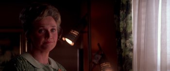 Movie still from “Born on the Fourth of July” (1989), directed by Oliver Stone – An older woman is standing in front of a mirror; Close Up shot, Over the shoulder angle