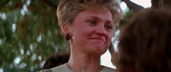 Movie still from “Born on the Fourth of July” (1989), directed by Oliver Stone – An older woman with a very big smile on her face; Close Up shot, Low angle