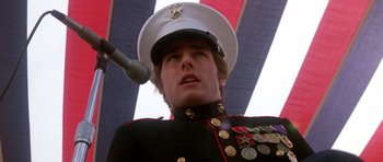 Movie still from “Born on the Fourth of July” (1989), directed by Oliver Stone – A man in a military uniform with medals on his hat; Close Up shot, Low angle