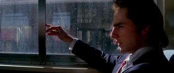 Movie still from “Born on the Fourth of July” (1989), directed by Oliver Stone – A man in a suit and tie sitting on a train window; Close Up shot, Over the shoulder angle