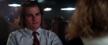Movie still from “Born on the Fourth of July” (1989), directed by Oliver Stone – A young man in a white dress shirt and a red tie; Close Up shot, Over the shoulder angle