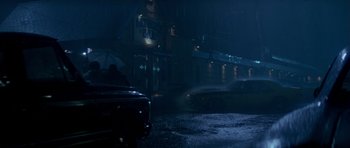 Movie still from “Born on the Fourth of July” (1989), directed by Oliver Stone – A car driving down a street at night; Wide shot, Low angle