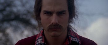 Movie still from “Born on the Fourth of July” (1989), directed by Oliver Stone – A person with a mustache; Close Up shot, Over the shoulder angle