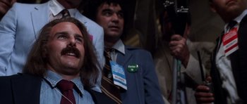 Movie still from “Born on the Fourth of July” (1989), directed by Oliver Stone – A group of people sitting in a room; Close Up shot, Low angle