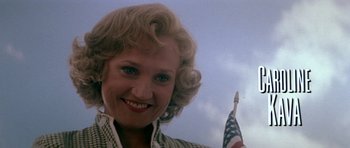 Movie still from “Born on the Fourth of July” (1989), directed by Oliver Stone – A person holding an american flag; Close Up shot, Low angle