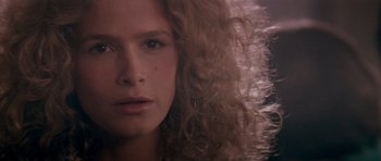 Movie still from “Born on the Fourth of July” (1989), directed by Oliver Stone – A person with long curly hair; Close Up shot, Over the shoulder angle