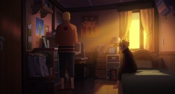 Two people are in a room with a television and computer
