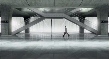 Movie still from “Boy Erased” (2018), directed by Joel Edgerton – A man walking in a large room with stairs; Extreme Wide shot, High angle