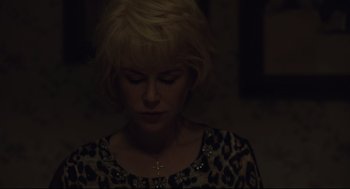 Movie still from “Boy Erased” (2018), directed by Joel Edgerton – A woman with blonde hair wearing a leopard print shirt; Close Up shot, High angle