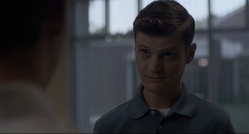 Movie still from “Boy Erased” (2018), directed by Joel Edgerton – A young man in a blue shirt looking at the camera; Close Up shot, Over the shoulder angle