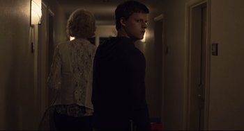 Movie still from “Boy Erased” (2018), directed by Joel Edgerton – A man and a woman standing in a hallway; Medium shot, Over the shoulder angle