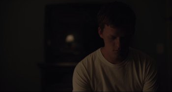 Movie still from “Boy Erased” (2018), directed by Joel Edgerton – A man sitting in a dark room with his eyes closed; Close Up shot, Low angle